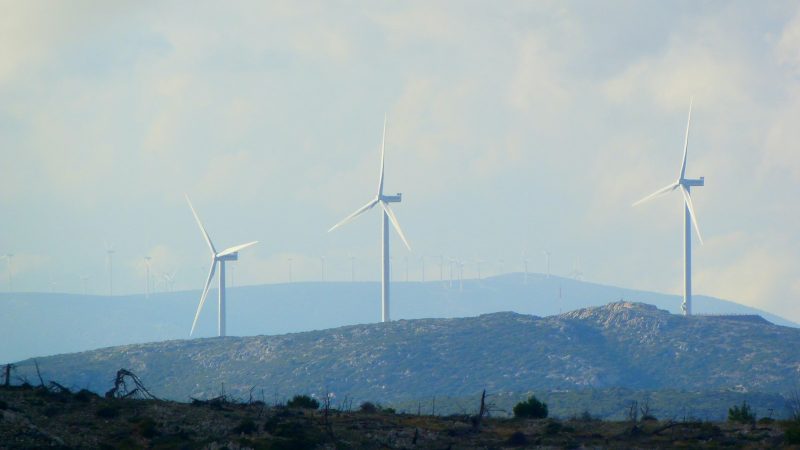 white wind turbines on green grass field during daytime